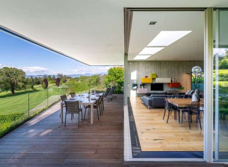 Experience luxurious indoor-outdoor living with this stunning modern home featuring a spacious deck overlooking a picturesque golf course.