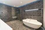 Experience modern luxury in this stunning bathroom, featuring a freestanding bathtub and a spacious walk-in shower.