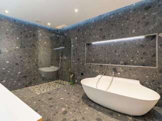 Experience modern luxury in this stunning bathroom, featuring a freestanding bathtub and a spacious walk-in shower.