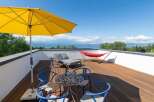 Enjoy breathtaking lake views from this stunning rooftop terrace, perfect for relaxation and entertaining.