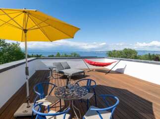 Enjoy breathtaking lake views from this stunning rooftop terrace, perfect for relaxation and entertaining.