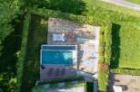 Experience luxury outdoor living with this stunning property featuring a sleek infinity pool and expansive wooden deck.