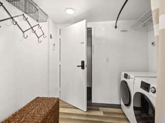 Discover modern convenience in this laundry area, featuring a stacked washer and dryer set for efficient space utilization.