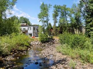 Experience serene living with this unique property nestled beside a tranquil creek.