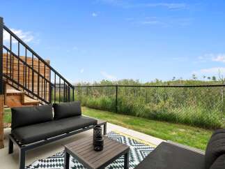 Enjoy outdoor living on this spacious patio, perfect for relaxing or entertaining.