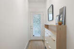Step into this inviting entryway, featuring a stylish console table with ample storage and a decorative mirror.
