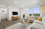 Experience modern living in this bright and airy living room, featuring a spacious sectional sofa perfect for relaxation and entertaining.