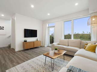 Experience modern living in this bright and airy living room, featuring a spacious sectional sofa perfect for relaxation and entertaining.