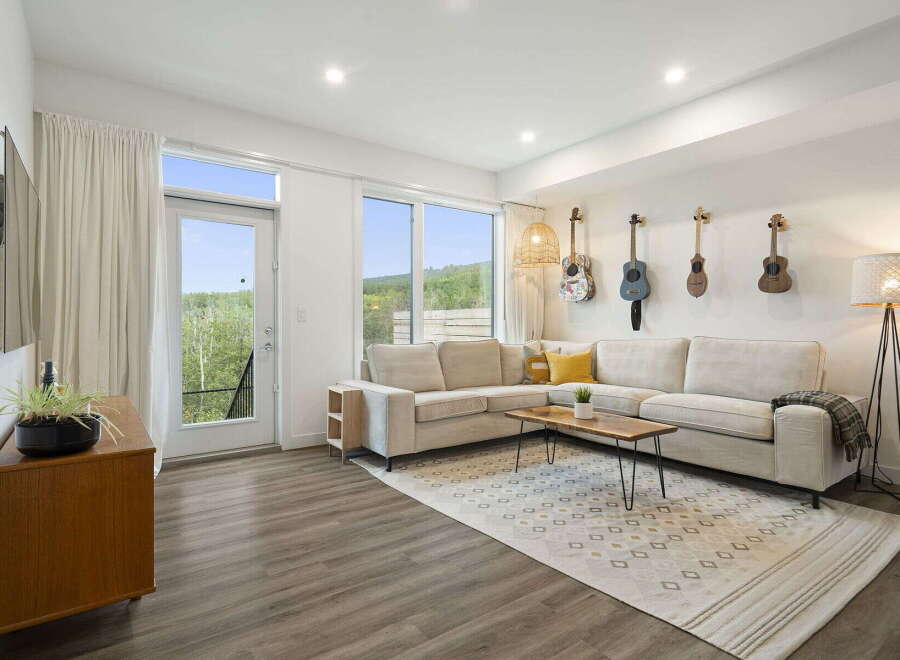 Experience modern living in this stylish living room, featuring a spacious sectional sofa perfect for relaxation and entertaining.