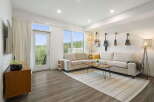 Experience modern living in this stylish living room, featuring a spacious sectional sofa perfect for relaxation and entertaining.