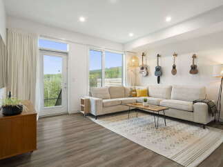 Experience modern living in this stylish living room, featuring a spacious sectional sofa perfect for relaxation and entertaining.
