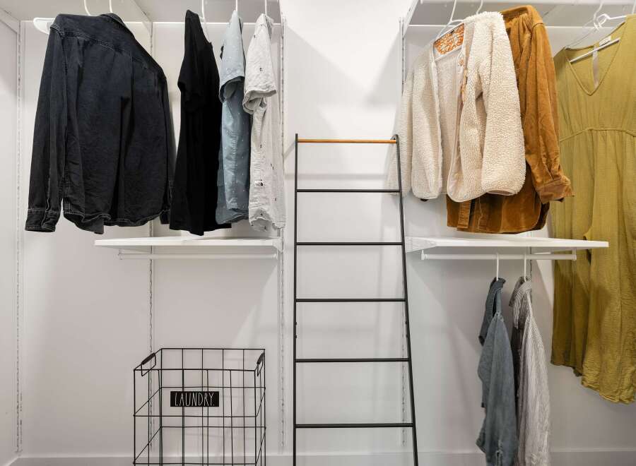 Discover organized living with this spacious walk-in closet, featuring ample shelving and hanging space for all your apparel.