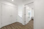 Step into this bright and airy hallway featuring a modern staircase and sleek white doors.