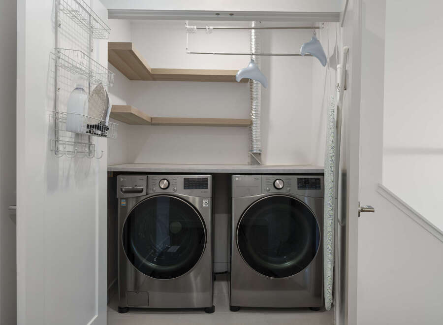 This laundry room features a modern LG washer and dryer set, perfect for handling large loads.