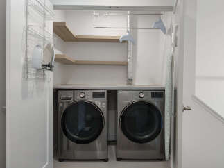This laundry room features a modern LG washer and dryer set, perfect for handling large loads.