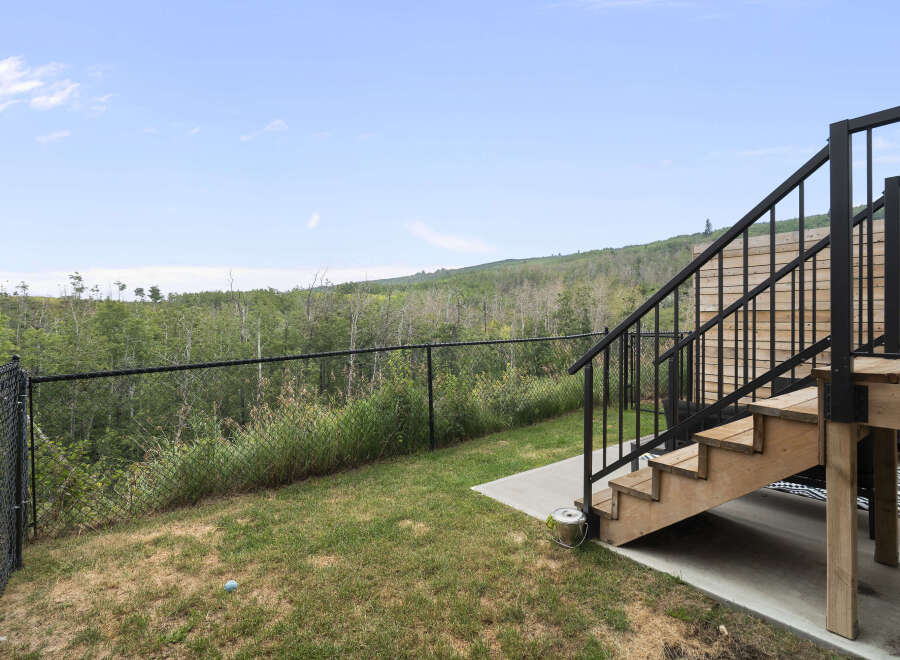 Enjoy the stunning natural views from this property's elevated deck, perfect for outdoor entertaining.