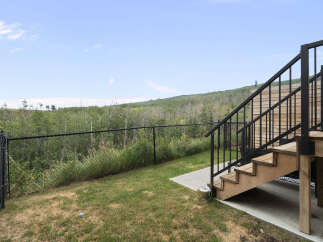 Enjoy the stunning natural views from this property's elevated deck, perfect for outdoor entertaining.