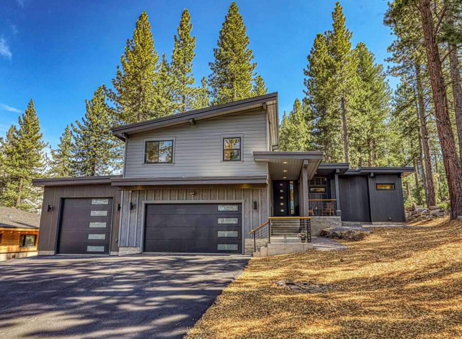 Discover modern mountain living in this stunning contemporary home nestled among tall pine trees.
