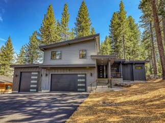 Discover modern mountain living in this stunning contemporary home nestled among tall pine trees.