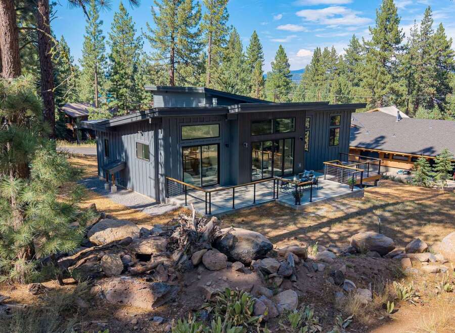 Experience modern living in this stunning contemporary home nestled amongst tall pine trees.
