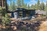Experience modern living in this stunning contemporary home nestled amongst tall pine trees.