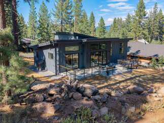 Experience modern living in this stunning contemporary home nestled amongst tall pine trees.