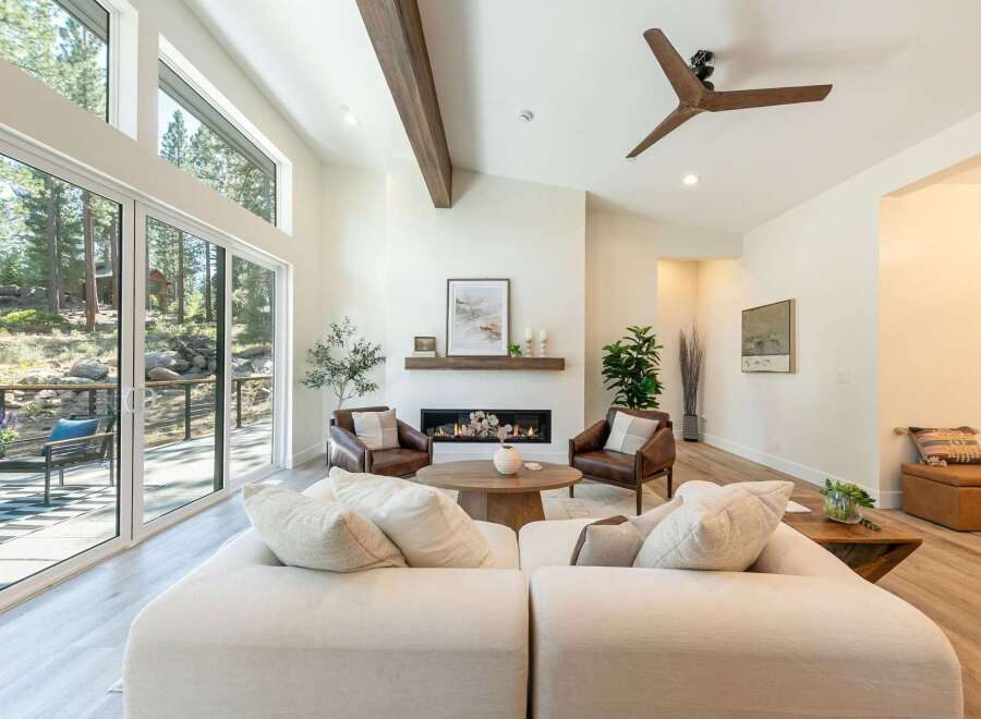 Experience modern mountain living in this stunning home featuring soaring ceilings and expansive windows that flood the space with natural light.