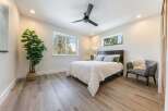 Experience serene living in this beautifully appointed bedroom, featuring a comfortable queen-size bed dressed in crisp white linens.