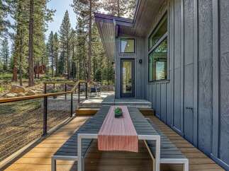 Experience modern mountain living with this stunning property featuring a spacious deck perfect for outdoor entertaining.