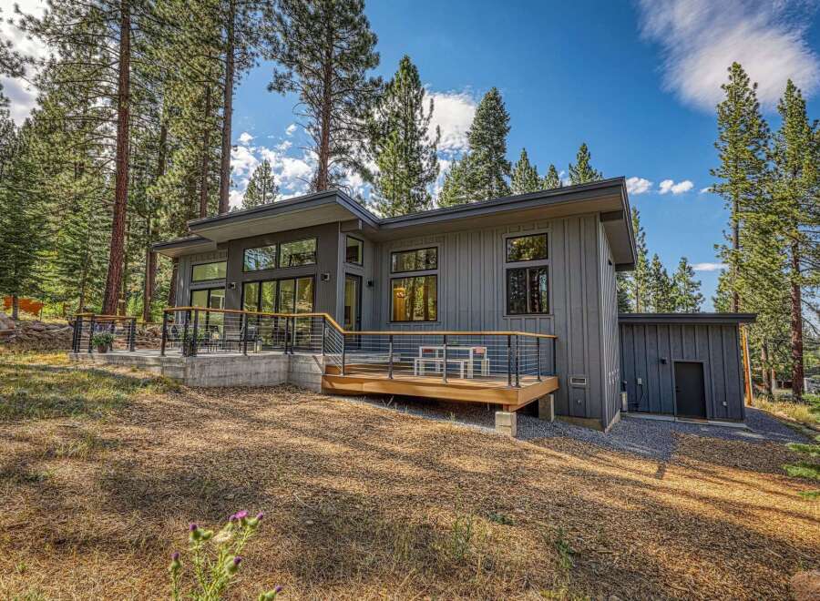 Experience modern mountain living in this stunning contemporary home nestled amongst tall pine trees.