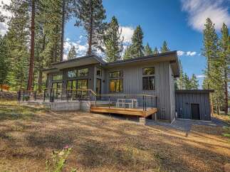 Experience modern mountain living in this stunning contemporary home nestled amongst tall pine trees.