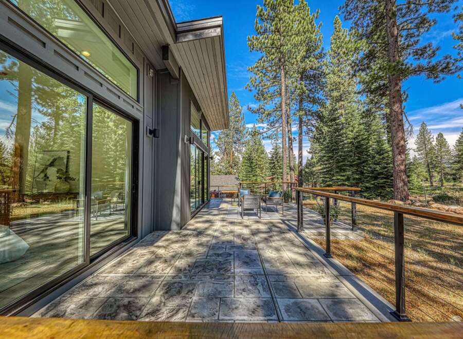 Experience modern living with this stunning home featuring expansive floor-to-ceiling windows that seamlessly blend indoor and outdoor spaces.