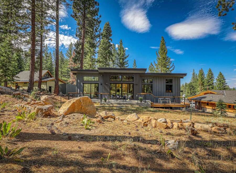 Experience modern mountain living in this stunning contemporary home nestled among tall pine trees.
