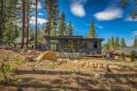 Experience modern mountain living in this stunning contemporary home nestled among tall pine trees.