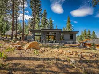 Experience modern mountain living in this stunning contemporary home nestled among tall pine trees.