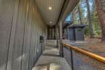 Experience modern mountain living with this stunning home featuring sleek vertical siding and a covered entryway.