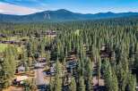 Nestled amidst a dense forest of towering pine trees, this property offers a serene and private retreat.