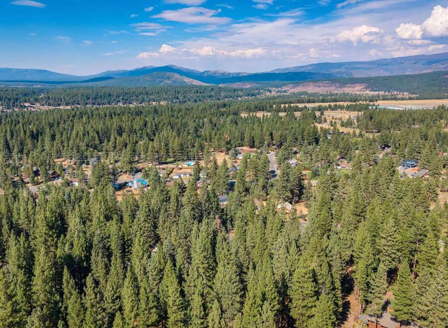 Nestled amidst a dense forest of mature pine trees, this property offers a serene and private retreat.