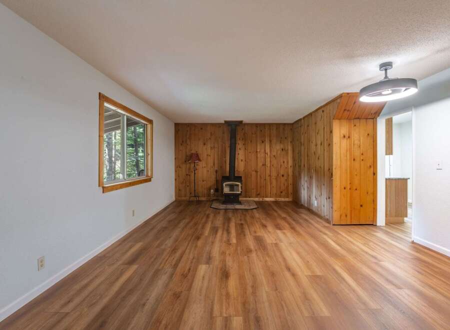 Step into this charming living space featuring a cozy wood-burning stove, perfect for chilly evenings.