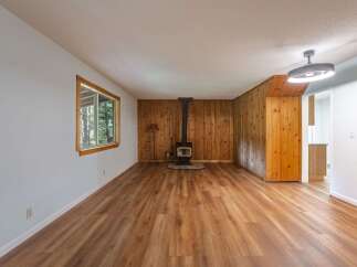 Step into this charming living space featuring a cozy wood-burning stove, perfect for chilly evenings.
