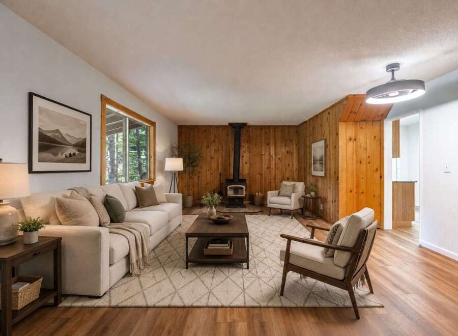 Experience cozy living in this inviting living room, featuring a striking wood-paneled accent wall and a modern wood-burning stove.