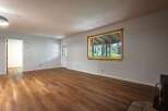 Step into this inviting living space featuring a bright and airy atmosphere, complemented by beautiful wood-look flooring that flows throughout the room.