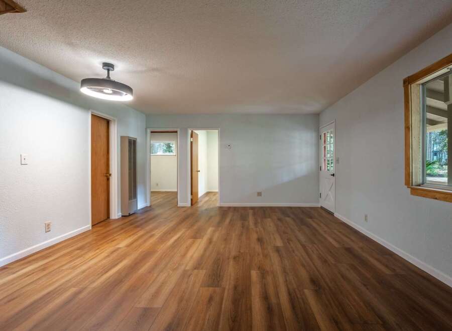 Step into this spacious living area featuring beautiful wood-look flooring that extends throughout the home.