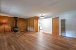Step into this inviting living space featuring a cozy wood-burning stove, perfect for chilly evenings.