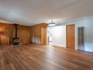 Step into this inviting living space featuring a cozy wood-burning stove, perfect for chilly evenings.