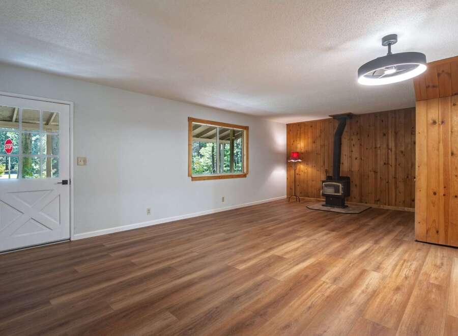 Step into this charming living space featuring a cozy wood-burning stove, perfect for chilly evenings.