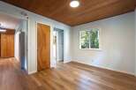 Step into this charming room featuring a warm wooden ceiling and durable laminate flooring.