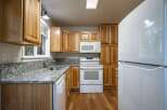 Discover this charming kitchen featuring warm wood cabinetry and sleek granite countertops.