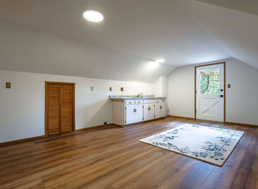 Discover this charming attic space, perfect for a home office or guest suite.