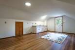 Discover this charming attic space, perfect for a home office or guest suite.